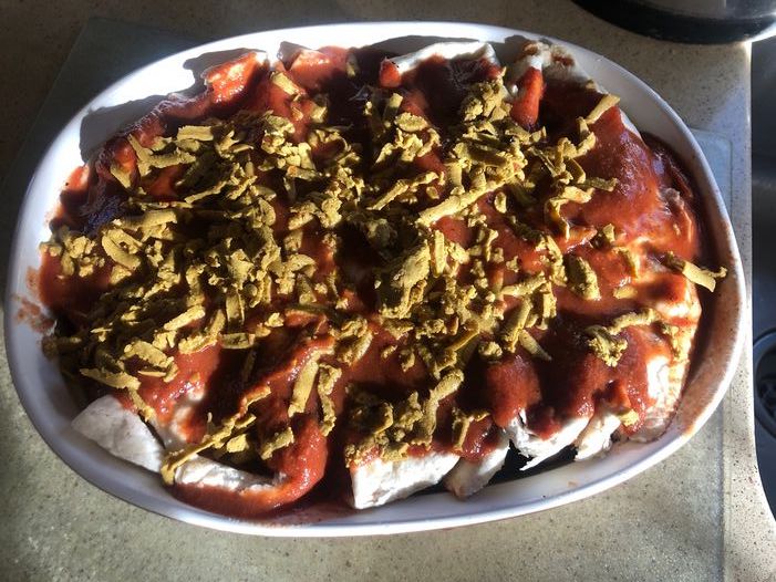 a casserole dish with enchiladas in it