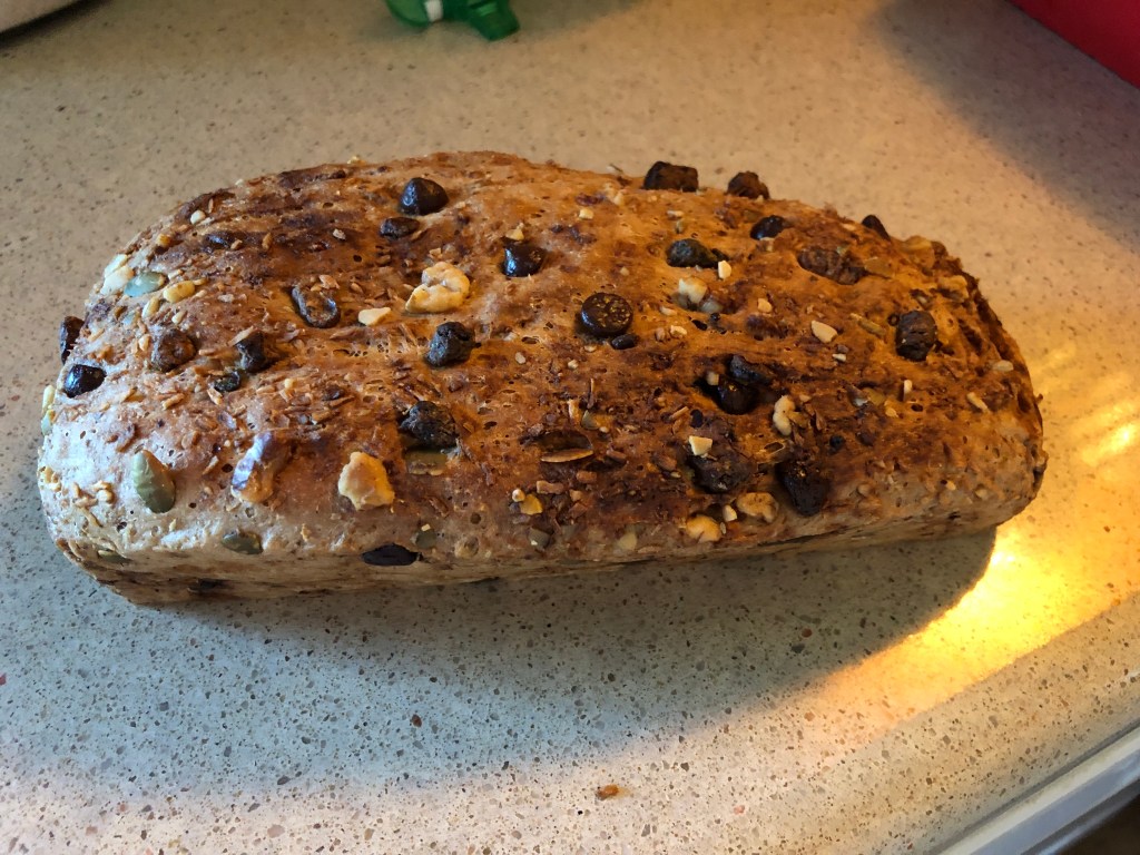 loaf of homemade bread with pipits, walnuts, dried dates, and chocolate chips