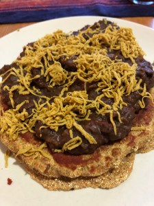 chili with cheese on top of a cornbread pancake