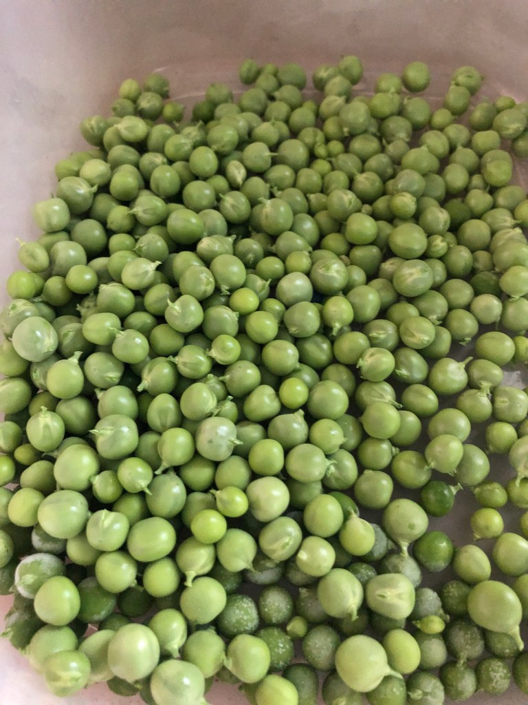 a bowl of fresh green peas