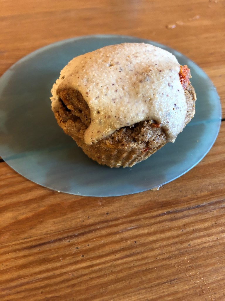 tomato cupcake with almond tofu frosting on a plate