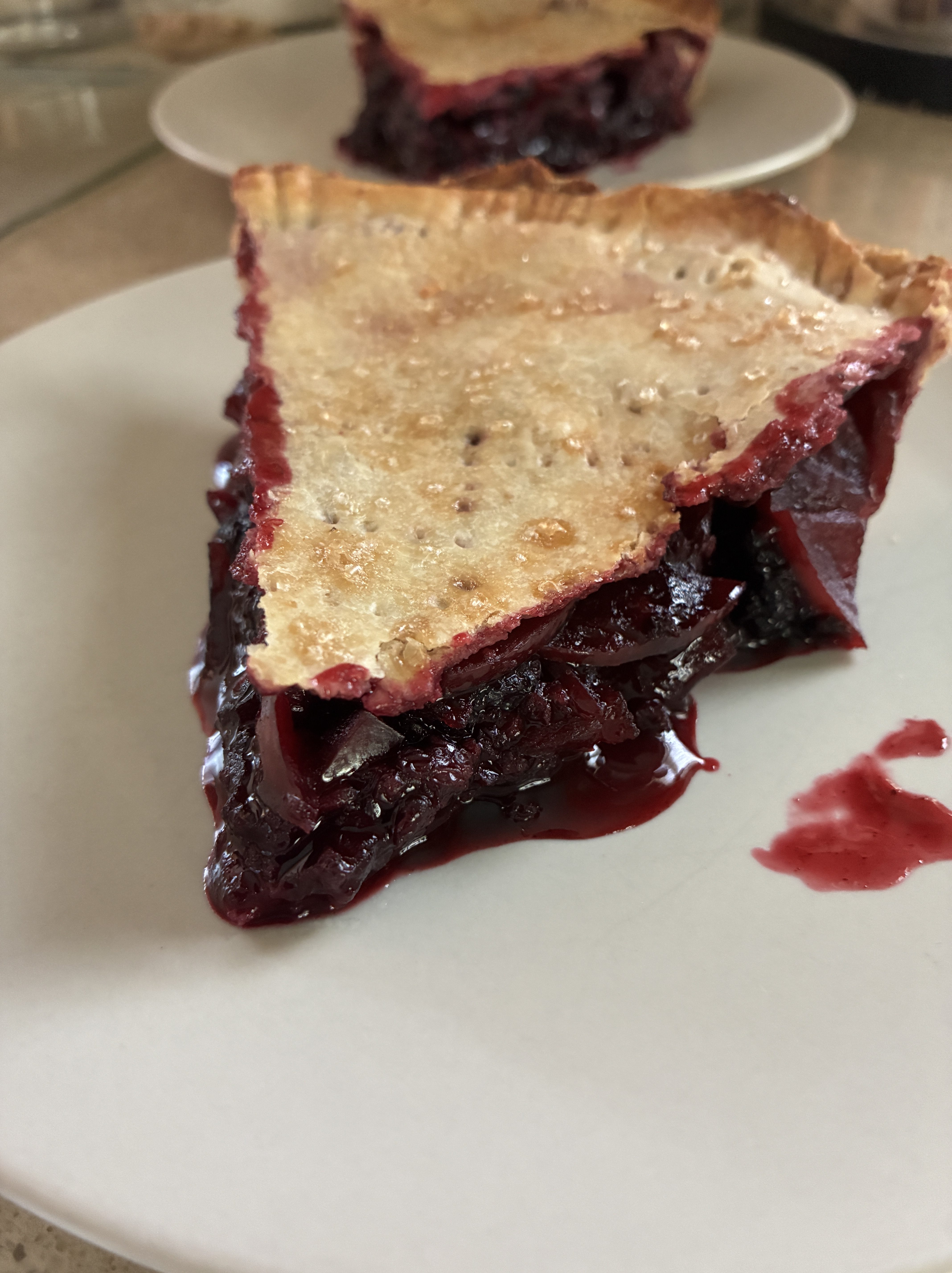 slice of apple raspberry pie on a plate